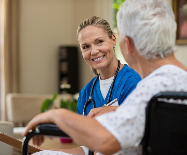 doctor talking with elderly patient