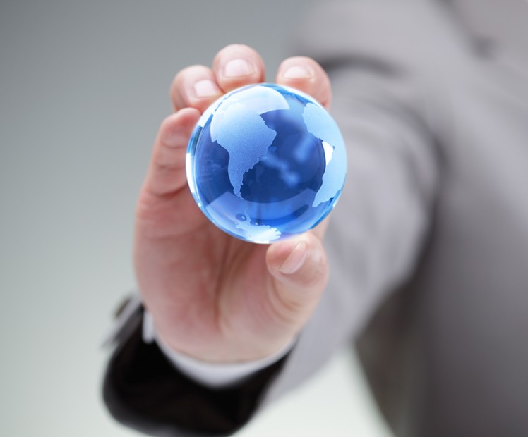 person holding mini globe