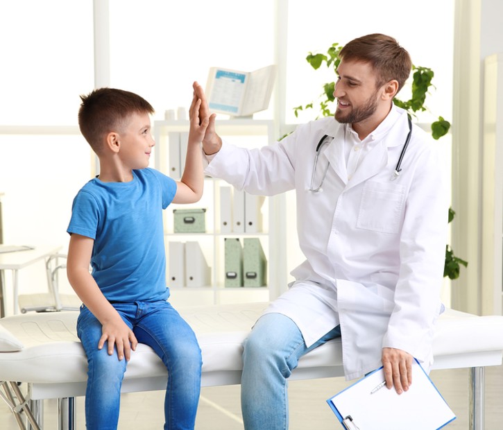 doctor high fiving young patient