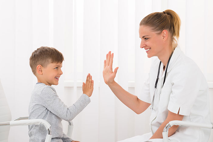 doctor high-fiving young patient