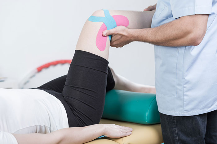 doctor rehabbing patients knee